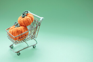 Shopping cart holding crochet pumpkins for autumn holidays © Agustin