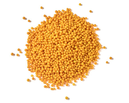 pile of gold round sprinkles isolated white background, yellow sugar pearls and sweet confectionery decoration in top view