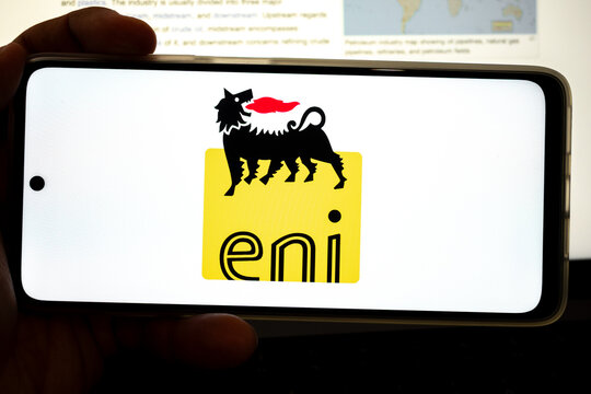 Hand holding device displaying eni energy company logo