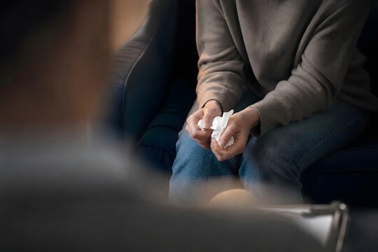 Crying Person Holding Tissue During Therapy Session