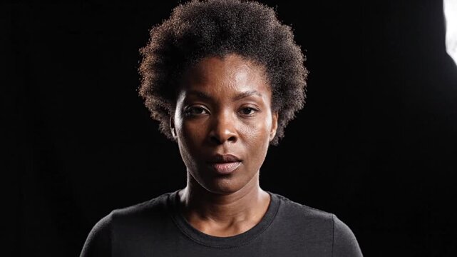 Black Woman with Afro Closing Eyes in Studio Portrait