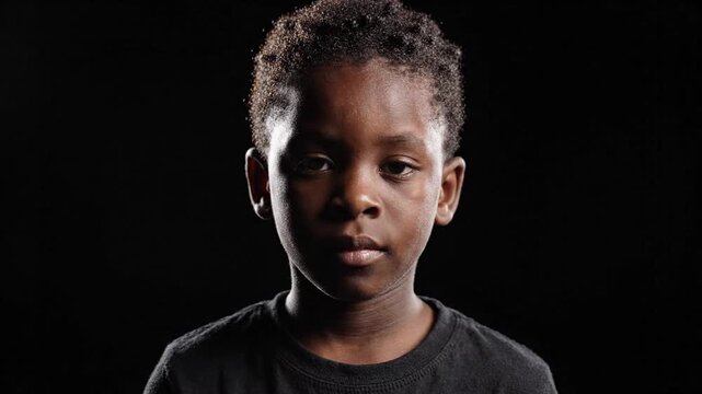 African Boy Opening Eyes in Cinematic Dark Portrait