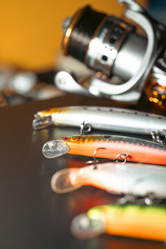 Selective focus view of plastic fish bait and spinning reel The Concept of angling gear