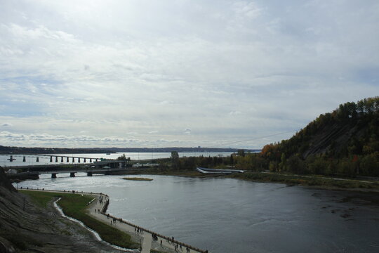 River Confluence with Bridge and Rocky Shoreline near Montmorency Falls, Quebec