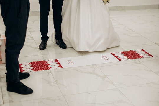 Bride and Groom Standing on Traditional Ukrainian Wedding Rushnyk