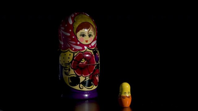 Spinning Matryoshka dolls on black background
