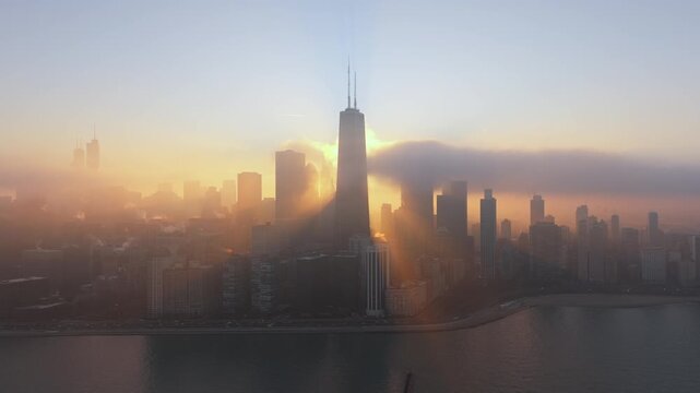 Chicago Skyline in Dense Fog and Golden Sunrise Over Lake Michigan