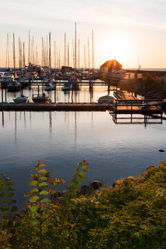 Scenic Harbor of Ballen in Denmark with Sailboats at Golden Hour