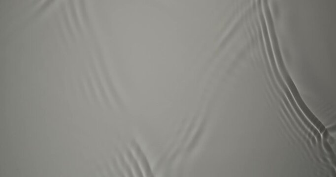 Minimal flow of soft transparency. Soft ripples move gently across the calm water, creating a sense of tranquility. The light reflections form a delicate, meditative pattern.