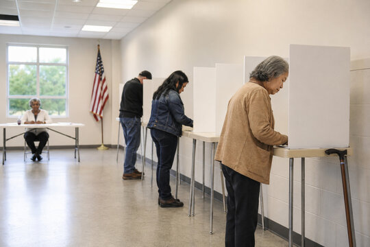 People lining up and casting votes at polling booths with a poll worker monitoring the election process.