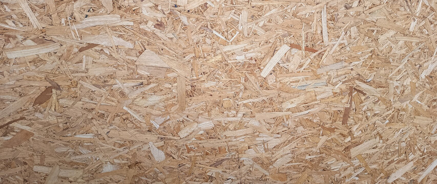 Wooden background. OSB boards made of brown wood chips sanded into wooden background, Wood plank texture background, surface texture of oriented board OSB. not ai