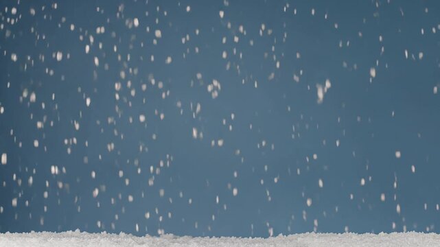 White snowflakes falling on a blue background