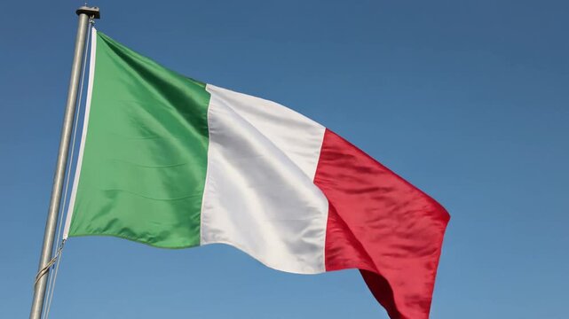 Italian flag waving against blue sky