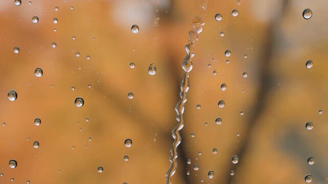 Raindrop falling down a window pane