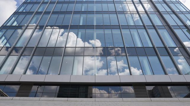 White clouds reflecting on modern office building windows