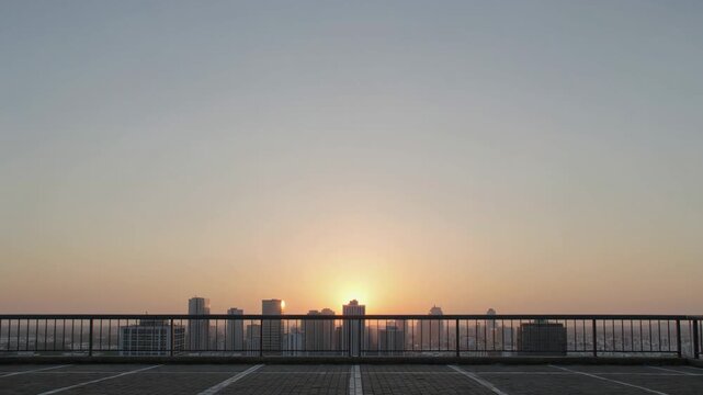 Rooftop parking lot with a city sunrise