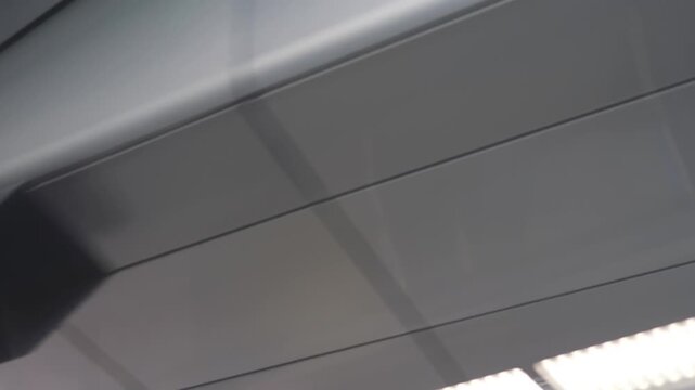 A view from a moving train of the ceiling of a train station in 4k slow motion 60fps
