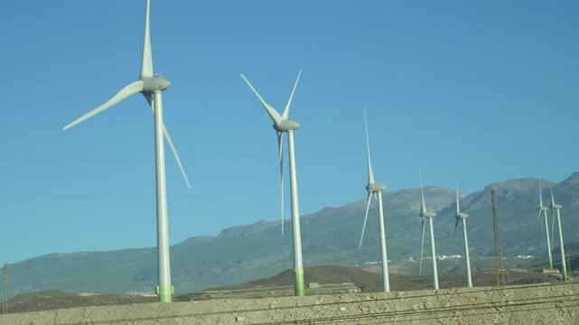 A view from a moving car of a wind farm in Gran Canaria in Spain in 4k slow motion 60fps