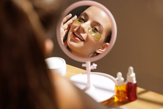 Woman Applying Korean Eye Patches for Skincare