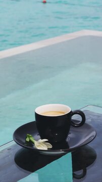Coffee in espresso cups for two people on luxury pool side on vacation Raw unedited vertical real video.