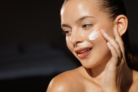 Young Woman Applying Cream for Radiant Skin
