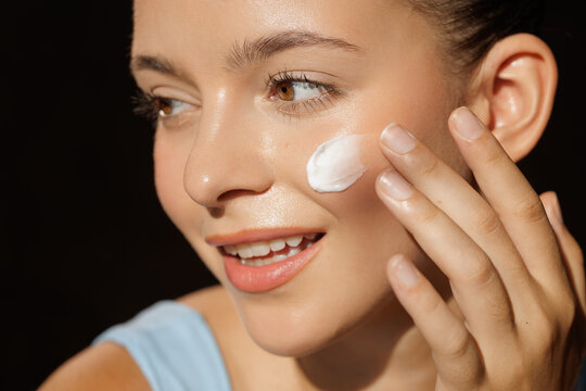 Woman Applying Cream for Korean Skin Care Routine