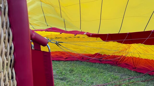 Hot Air Balloon Inflating. Hot Air Balloon fire flame. Hot air from a gas burner fills the dome of the balloon.