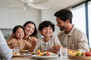 Obraz premium Happy family having breakfast together at home with joyful smiling kids
