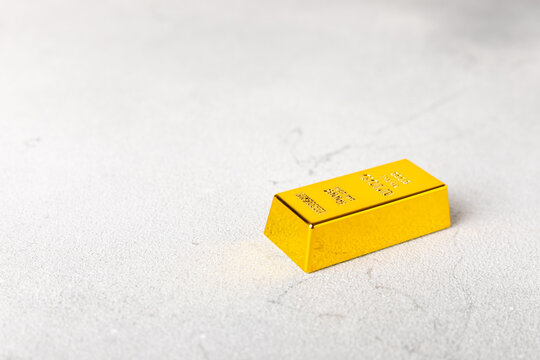 Gold bars, gold nuggets and US dollar banknotes. gold bullion and precious metals representing wealth, investment, financial security, savings, prosperity, luxury, capital, banking and global finance.