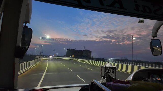 Forward Facing Windshield POV From Commercial Bus Navigating Elevated Highway Curve At Twilight