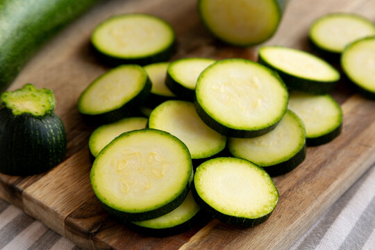 Raw Green Organic Zucchini on a Wooden Board, side view. Close-up.