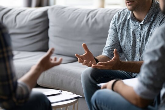 Clinical Psychologist Conducts Cognitive Behavioral Therapy Session in Office Setting With Clients
