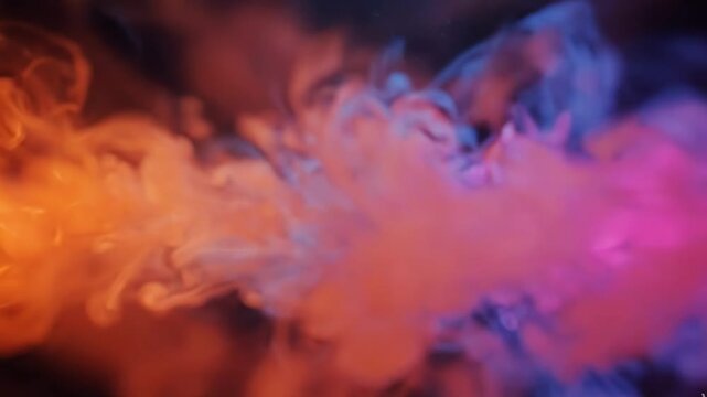 Abstract colorful ink smoke swirling in water on black background