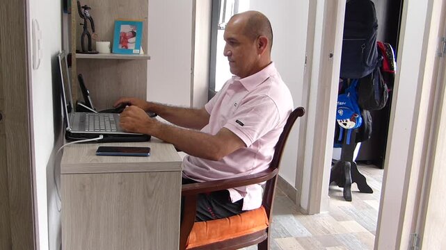 Young boy taking a smartphone to play games while interrupting his father working from home on a laptop computer