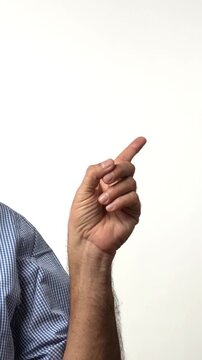 Indian Asian senior businessman with white beard confidently pointing with both hands to direct attention towards an important place or thing