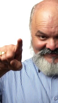 Indian Asian senior businessman with a white beard smiling and pointing both hands straight ahead