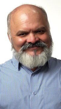 Indian Asian senior businessman with a white beard proudly showing victory gestures with both hands giving thumbs up, expressing success and joy 