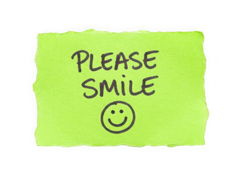 Bright green sticky note with please smile text and a happy face drawing