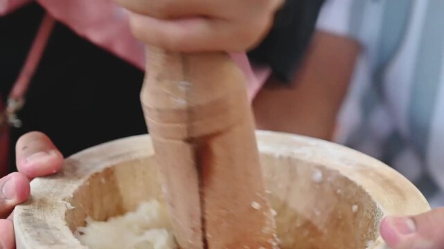 Traditional Mochi Being Pounded in a Wooden Mortar