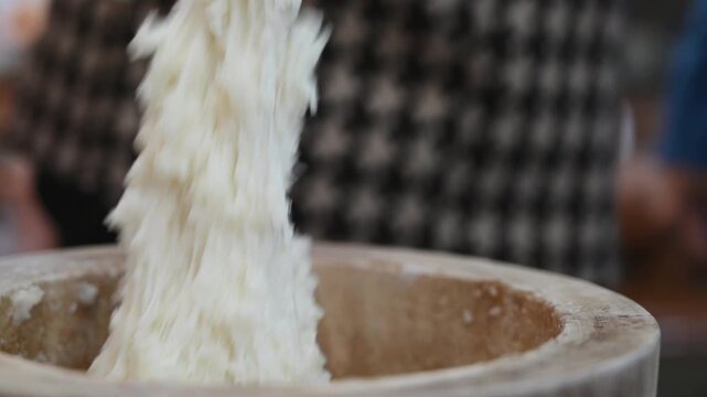 Traditional Mochi Being Pounded in a Wooden Mortar