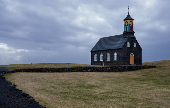 Hvalsneskirkja, a historic black stone church against a cloudy sky in rural reykjanes, peninsula iceland. Place of worship, chapel icelandic churches