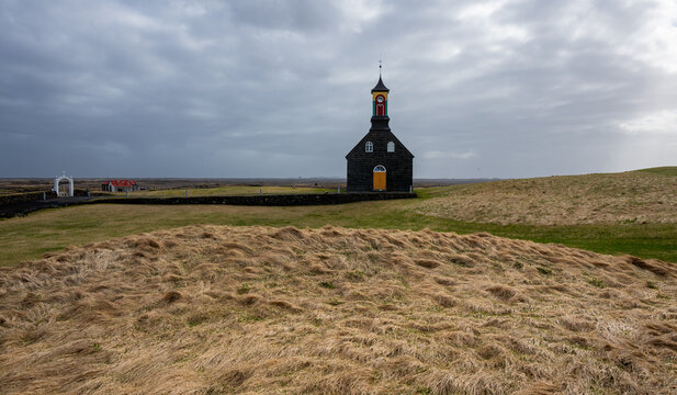 Hvalsneskirkja, a historic black stone church against a cloudy sky in rural reykjanes, peninsula iceland. Place of worship, chapel icelandic churches