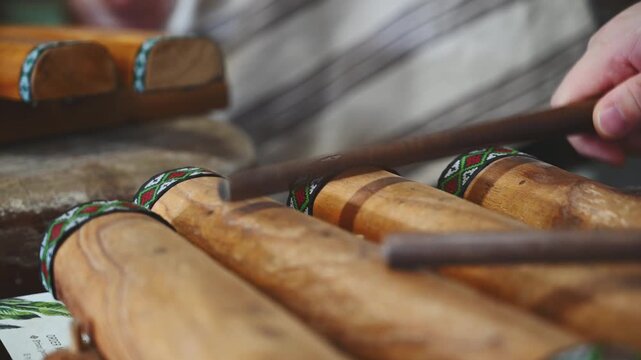 Hands Playing a Traditional Wooden Xylophone in Taiwan