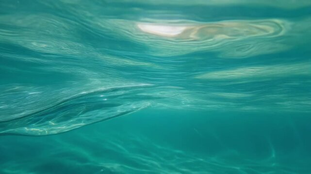 Close-up view of a clear underwater wave with light reflections