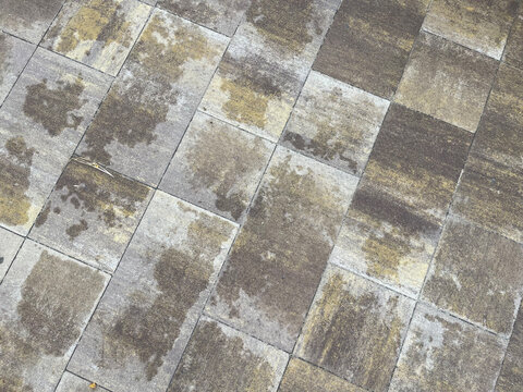 exture of wet concrete paving slabs with water stains after rain, top view background