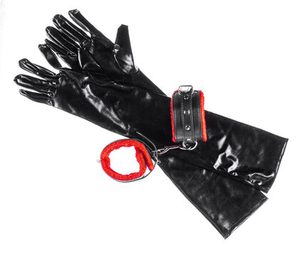 Latex black fetish gloves and accessories isolated on white background