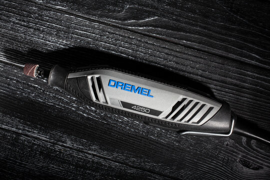 dremel multitool on black wood background top view