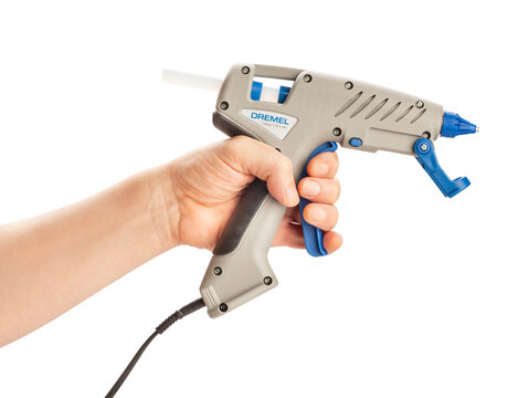 dremel glue gun in hand path isolated on white