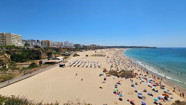View from pier over Praia da Rocha beach, cliffs and blue sea