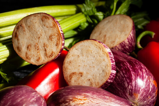 sliced jewel marble eggplant vegetable mix on black background